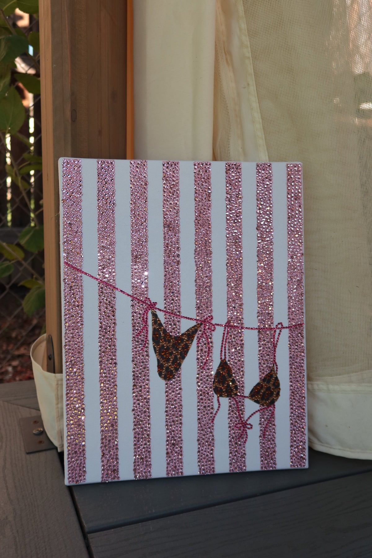 Finished pink striped bikini rhinestone art kit on a wood canvas panel